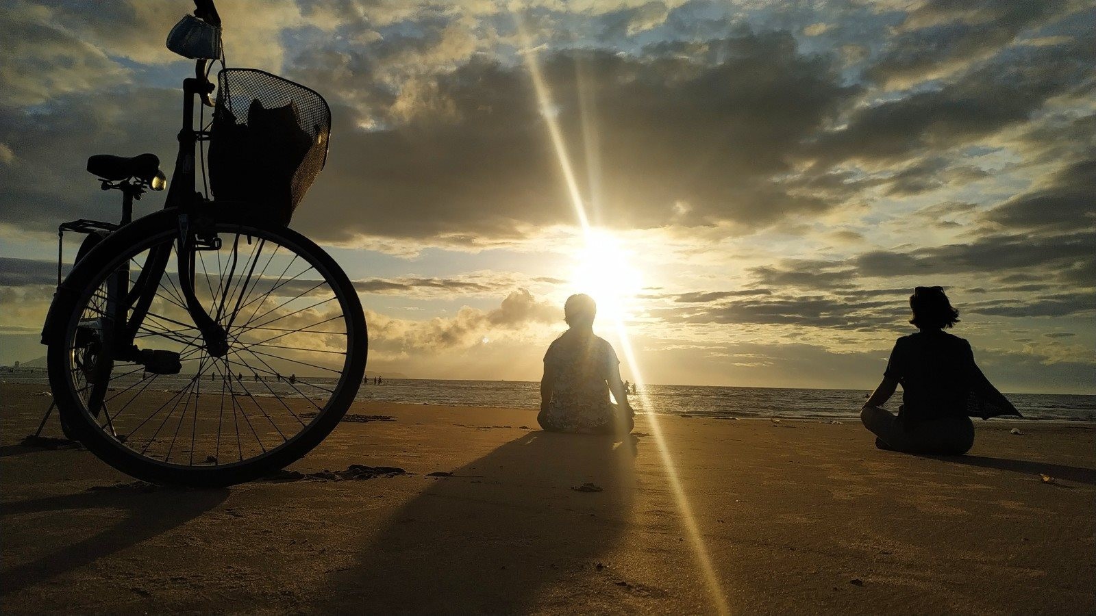 Một số người khác đón bình minh bằng cách ngồi trên bãi cát hướng về phía mặt trời để hưởng nắng sớm.