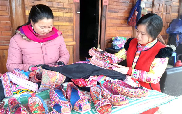 Phụ nữ người Xạ Phang cùng sản phẩm giày và trang phục truyền thống. Phụ nữ người Xạ Phang cùng sản phẩm giày và trang phục truyền thống.